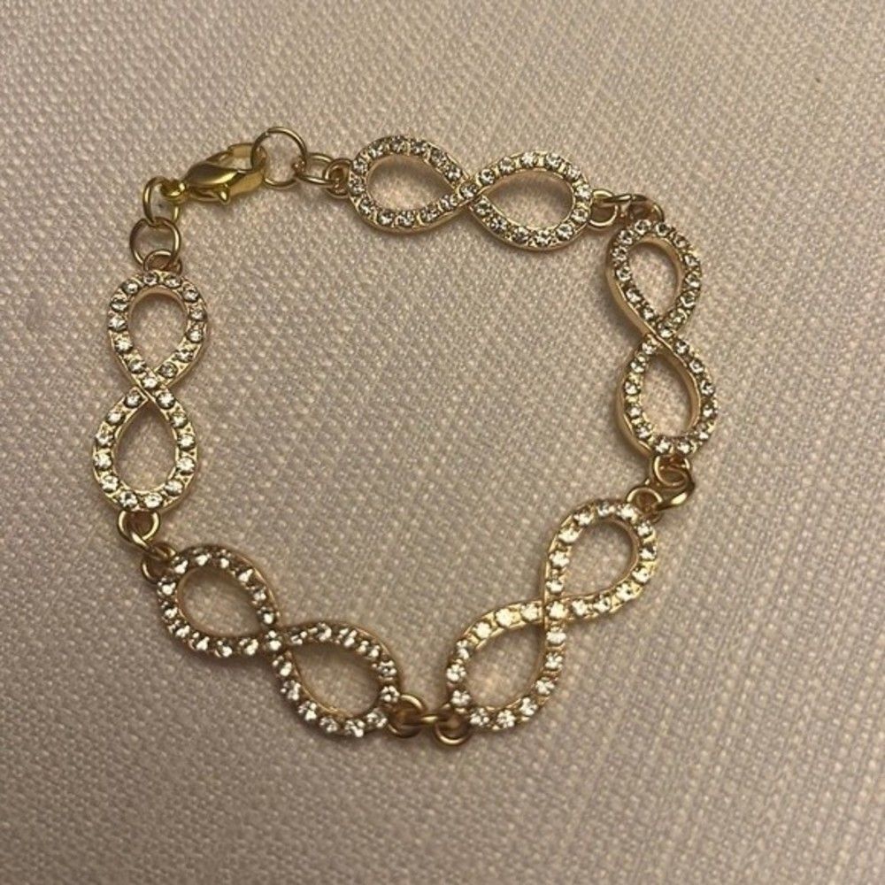 Handcrafted gold tone Infiniti charm with clear crystal bracelet